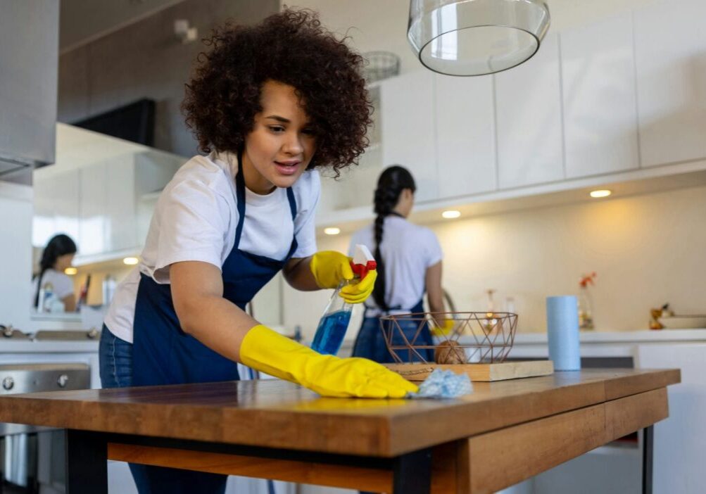 team of professiona cleaners cleaning up a kitchen